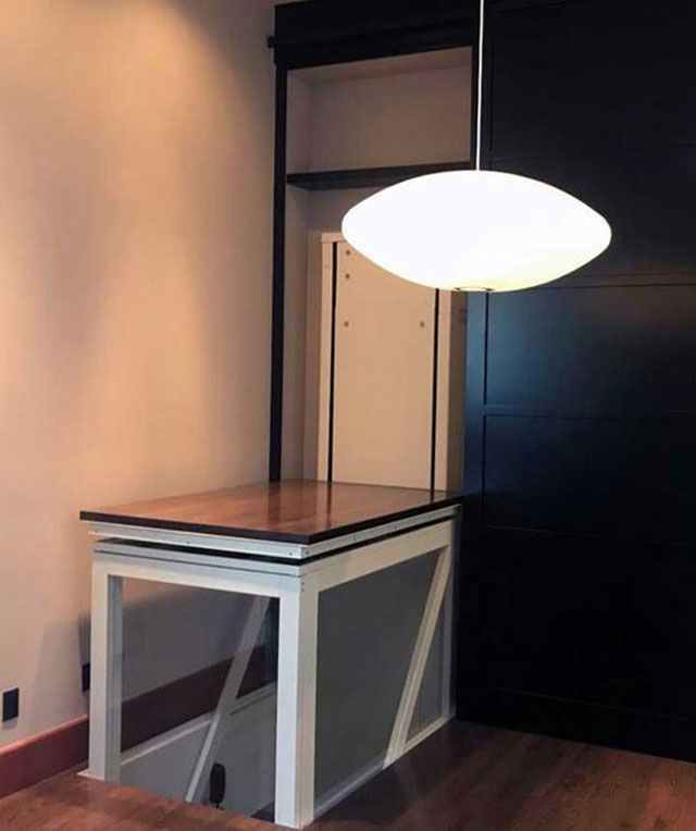 A Room with A Table and A Lamp Hanging from The Ceiling — Master Lifts Cairns in Cairns, QLD