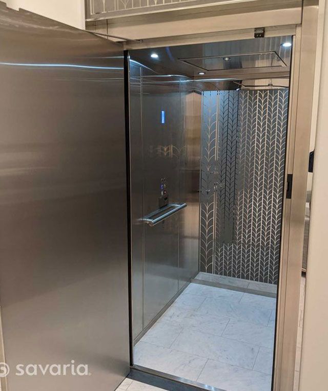 A Stainless Steel Elevator with The Door Open — Master Lifts Cairns in Cairns, QLD