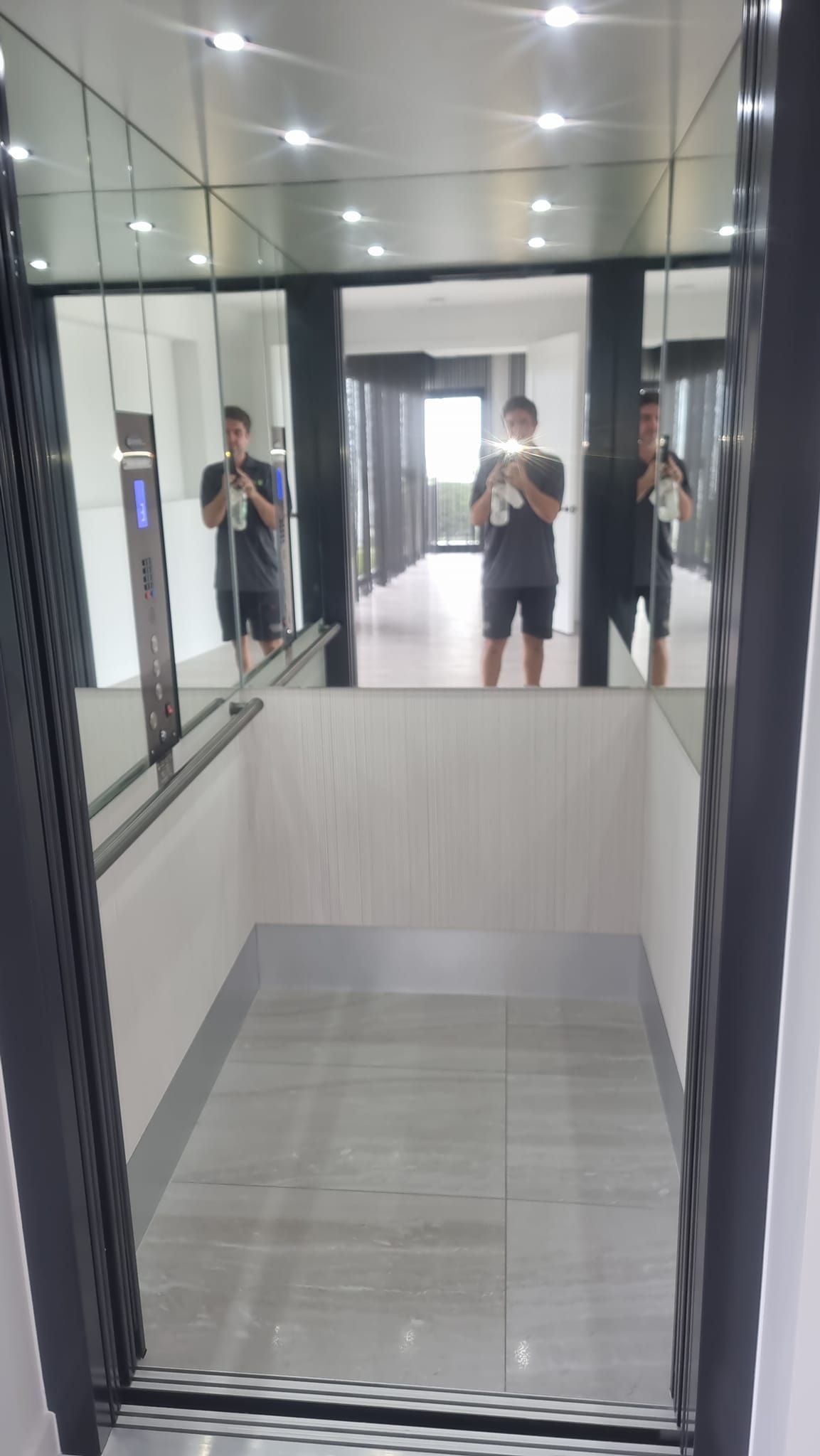A Man Is Taking a Picture of Himself in A Mirror in An Elevator  — Master Lifts Cairns in Port Douglas, QLD