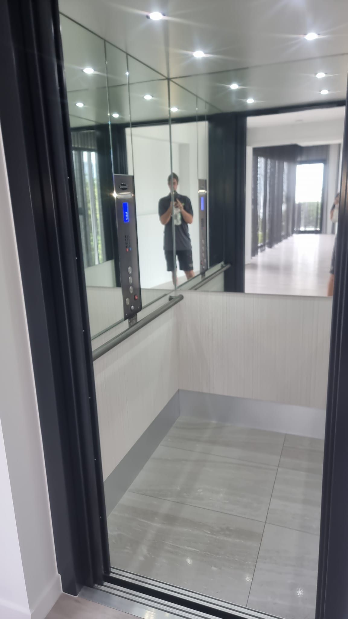 A Man Is Taking a Picture of Himself in An Elevator  — Master Lifts Cairns in Port Douglas, QLD