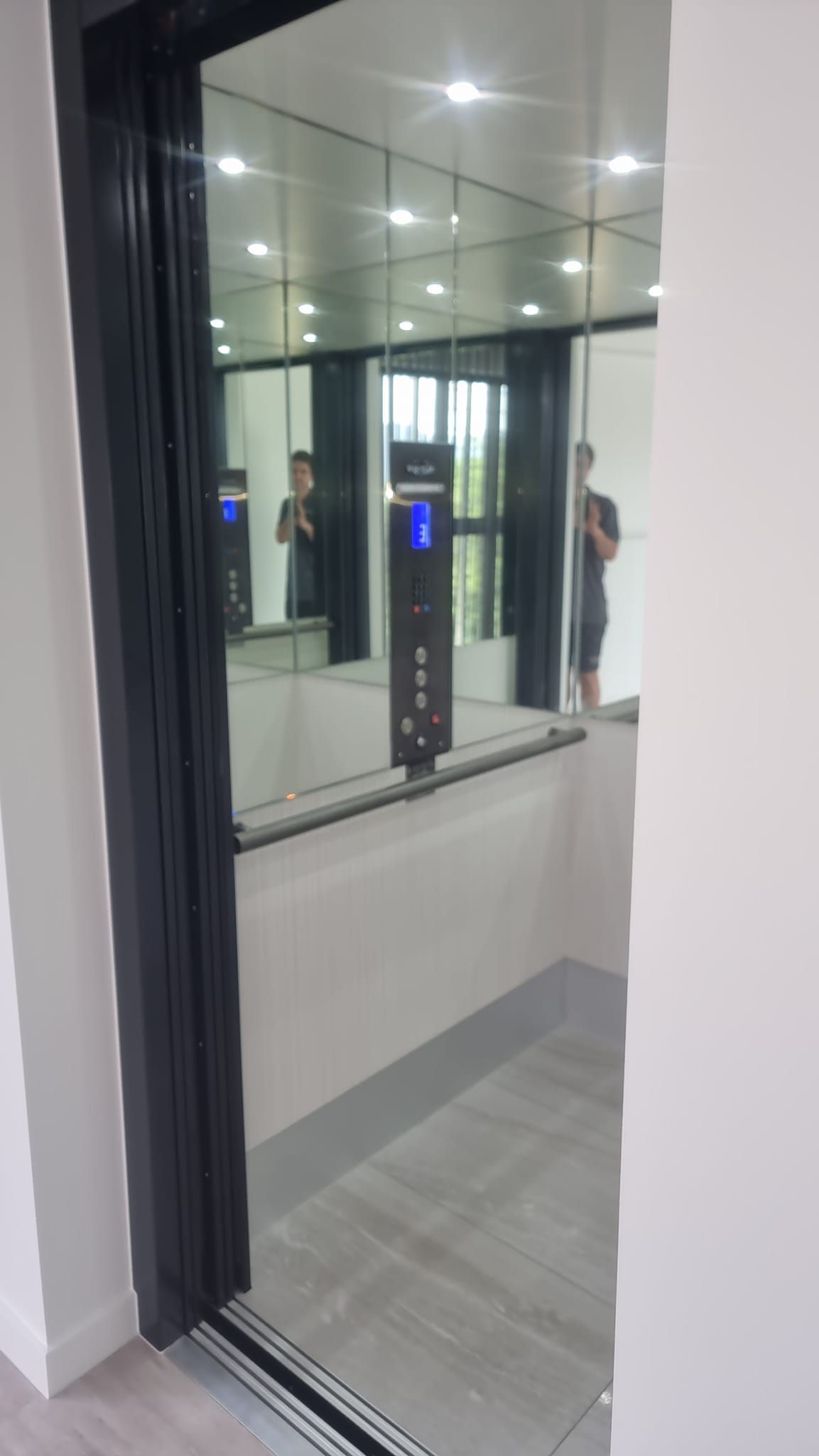 A Person Is Standing in An Elevator with A Mirror on The Wall — Master Lifts Cairns in Cairns, QLD