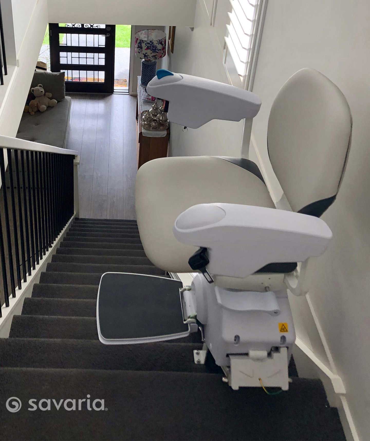 A White Chair Is Sitting on A Staircase in A Room — Master Lifts Cairns in Cairns, QLD