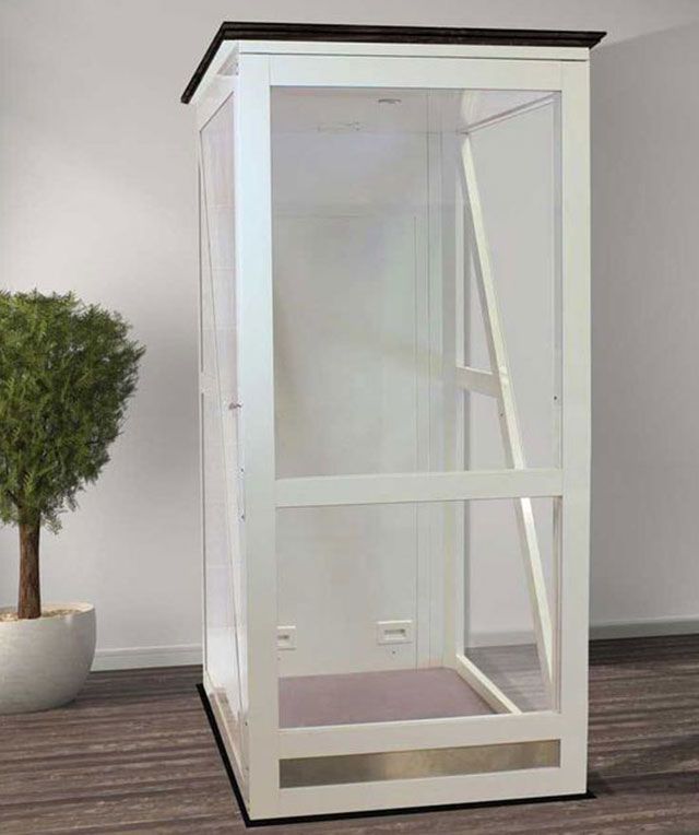 A White Elevator Is Sitting in A Room Next to A Potted Plant — Master Lifts Cairns in Cairns, QLD