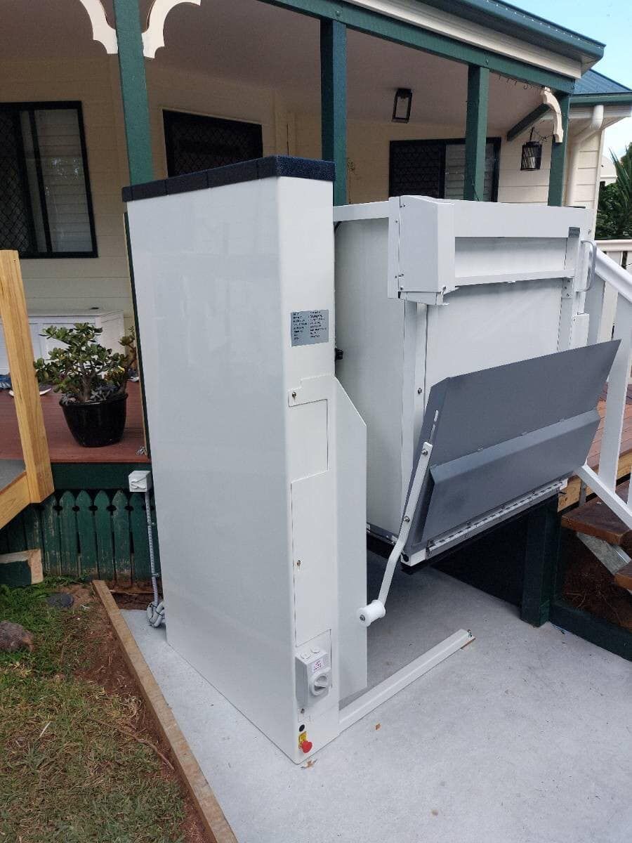 A White Lift Is Sitting on The Side of A House — Master Lifts Cairns in Cairns, QLD