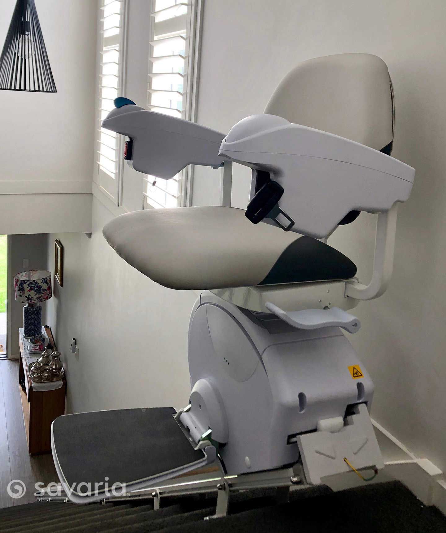 A White Chair Is Sitting on A Staircase in A Room — Master Lifts Cairns in Cairns, QLD