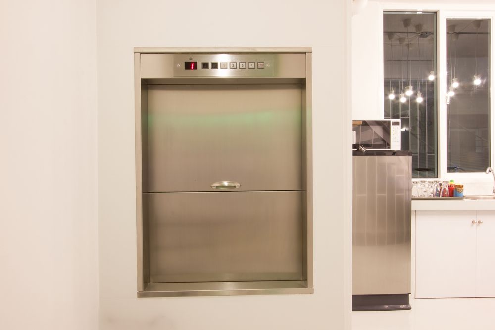 A Stainless Steel Elevator Is Built Into a Wall in A Kitchen — Master Lifts Cairns in Cairns, QLD