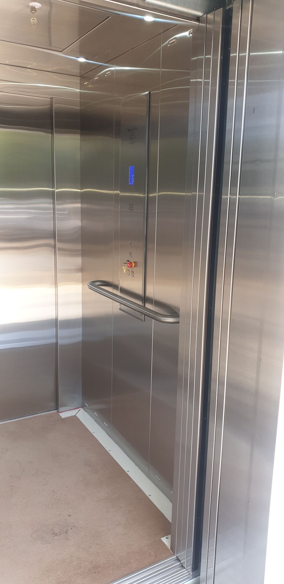 A Close up Of a Stainless Steel Elevator with A Door Open — Master Lifts Cairns in Cairns, QLD