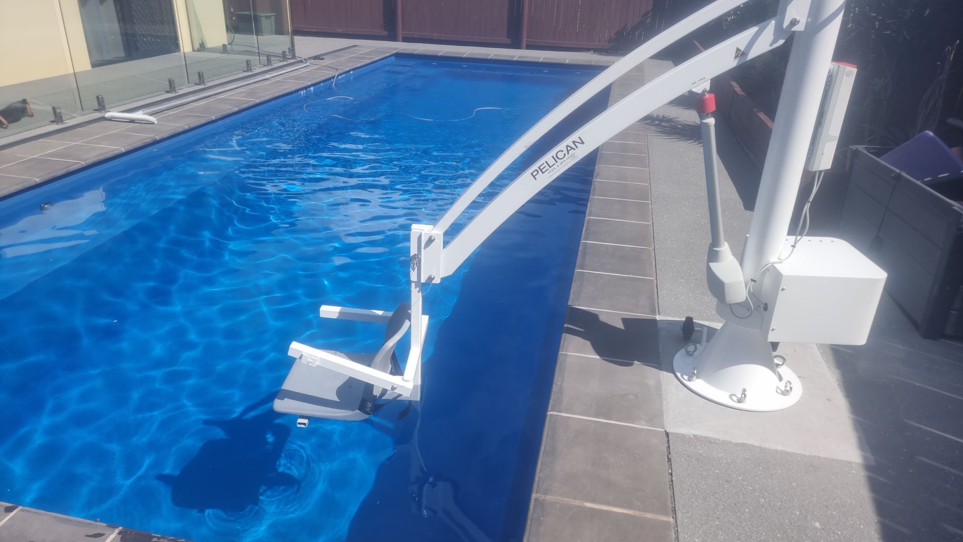 A Swimming Pool with A Lift Attached to The Side of It — Master Lifts Cairns in Cairns, QLD