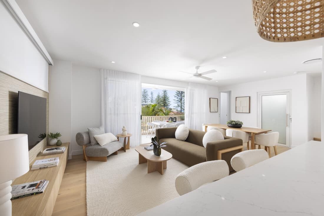 A Living Room with A Couch , Chair , Table and Television — Master Lifts Cairns in Cairns, QLD