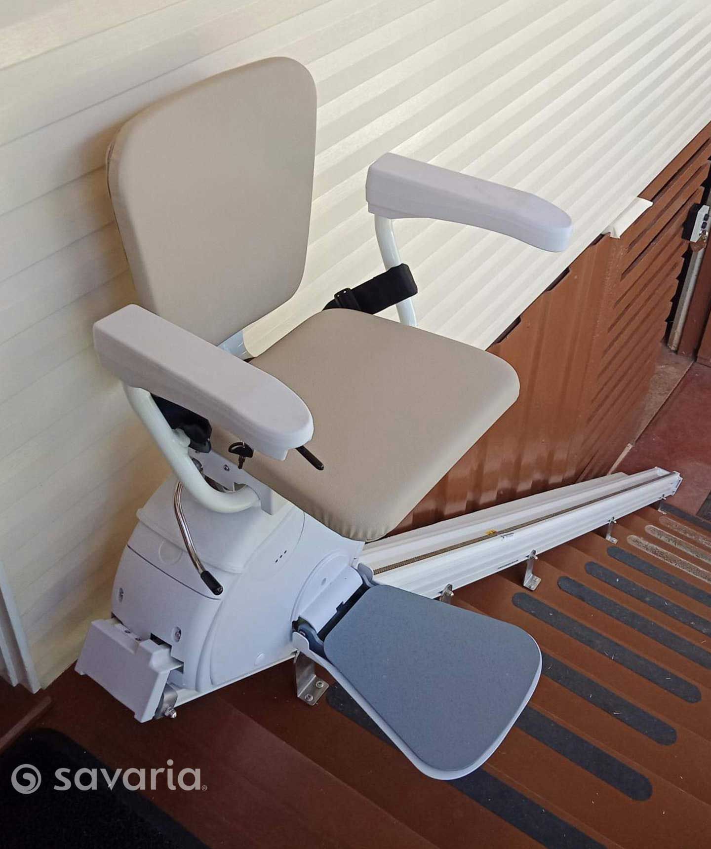 A Stair Lift Is Sitting on A Wooden Floor Next to A Wall — Master Lifts Cairns in Cairns, QLD
