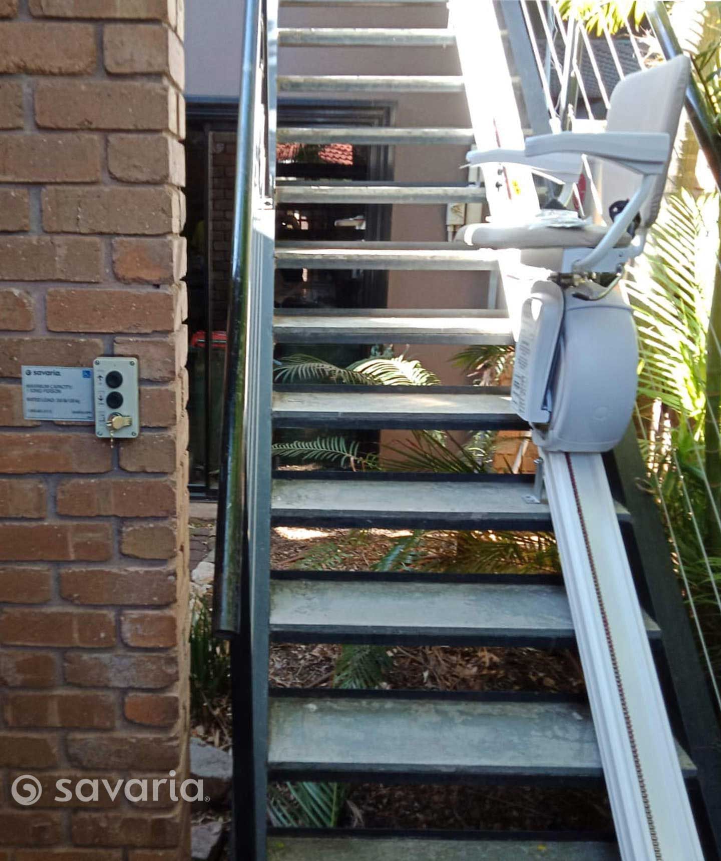 A Set of Stairs with A Stair Lift Attached to Them — Master Lifts Cairns in Cairns, QLD