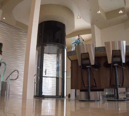 A Bar with Stools and A Elevator in The Background — Master Lifts Cairns in Cairns, QLD