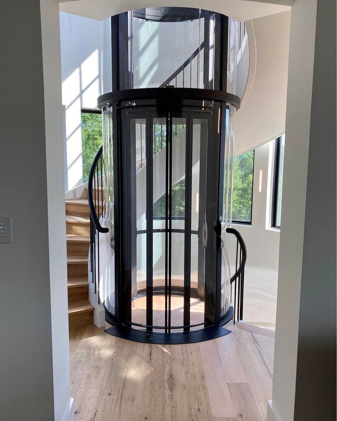 An Elevator with A Glass Door and Stairs in The Background — Master Lifts Cairns in Cairns, QLD