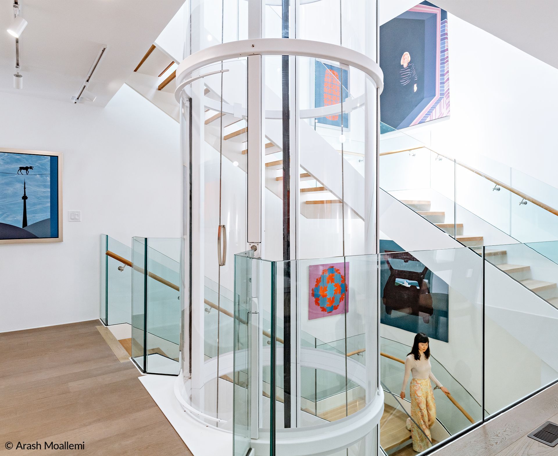 A Woman Is Walking Down a Spiral Staircase in A Building — Master Lifts Cairns in Cairns, QLD