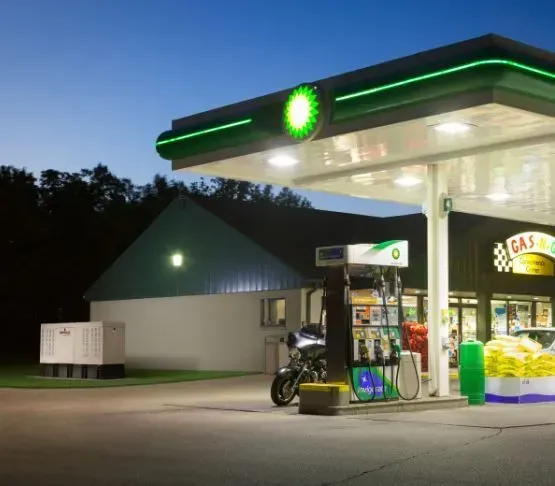 A bp gas station with a motorcycle parked in front of it