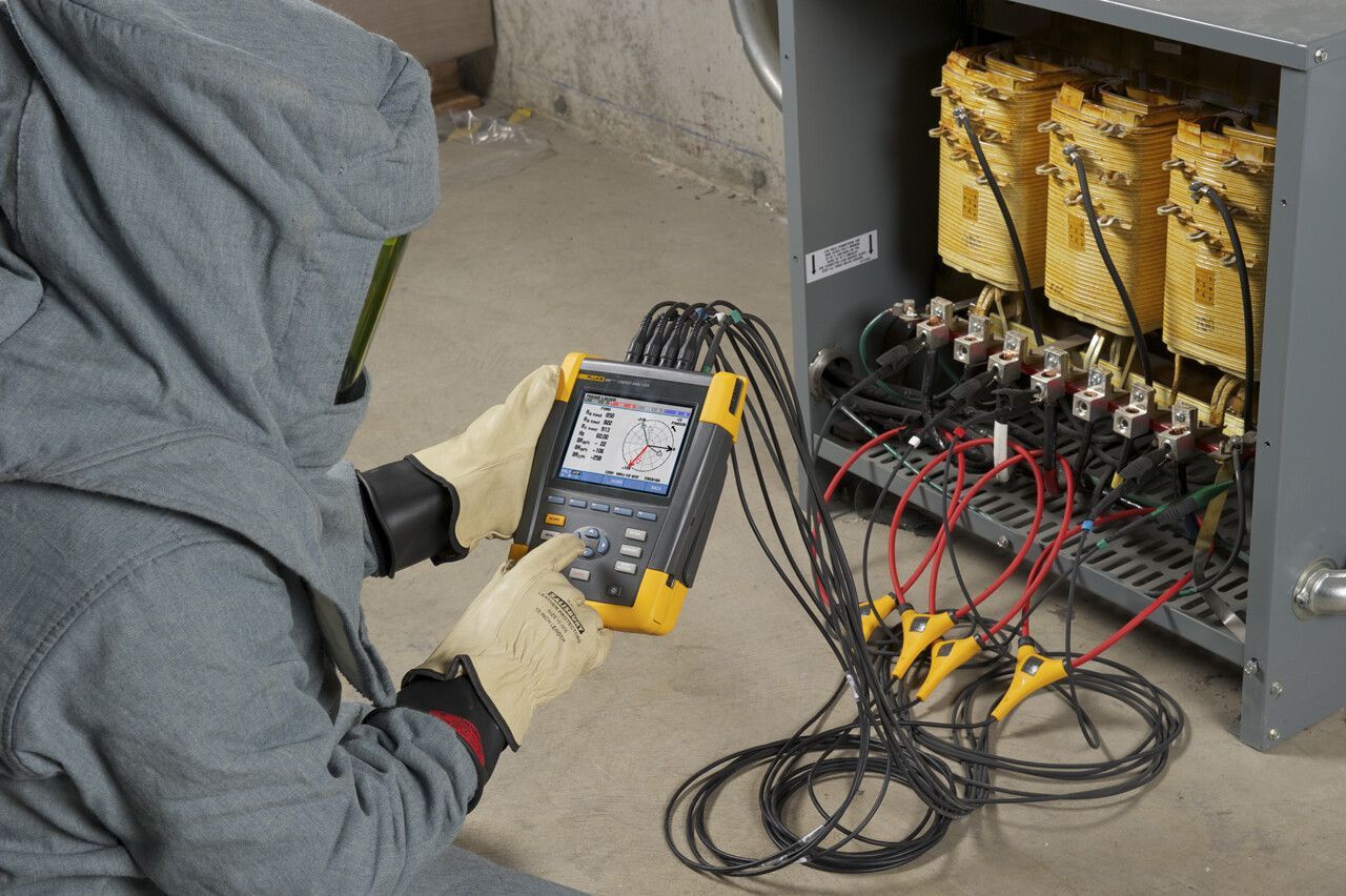 A man is using a device to test a box of batteries.