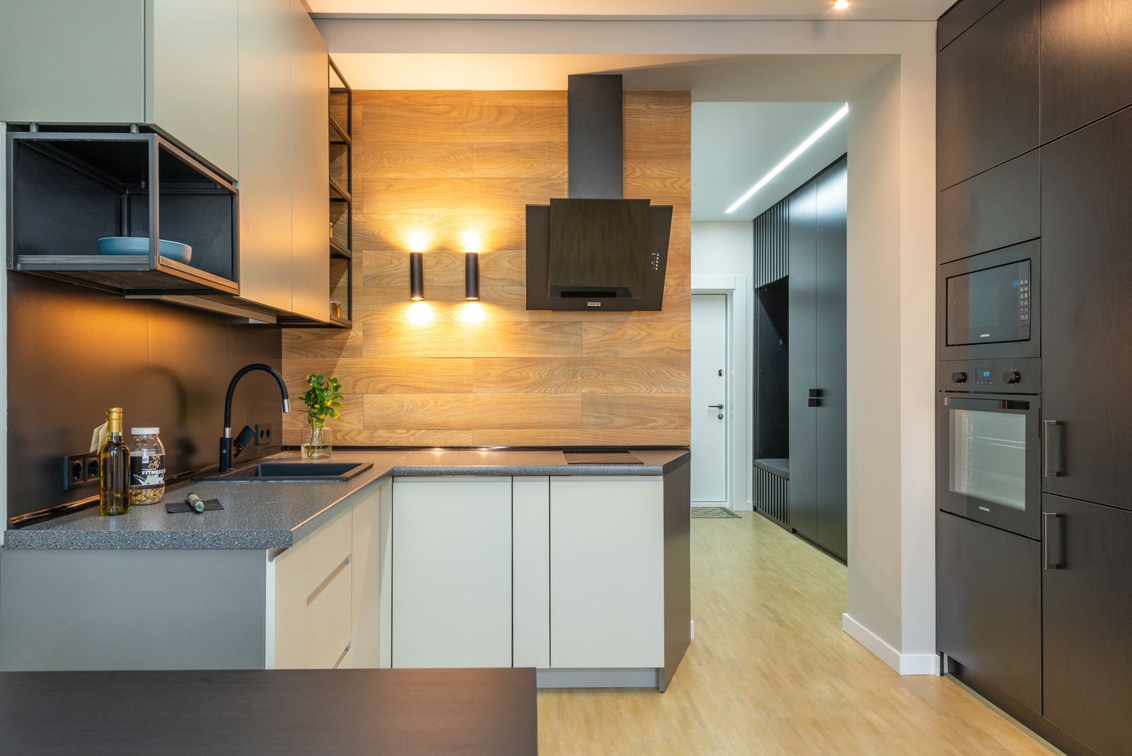 A kitchen with white cabinets and stainless steel appliances