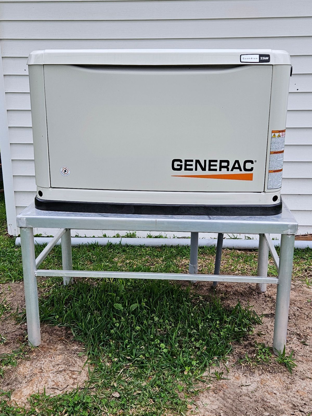 A generac generator is sitting on top of a metal stand.