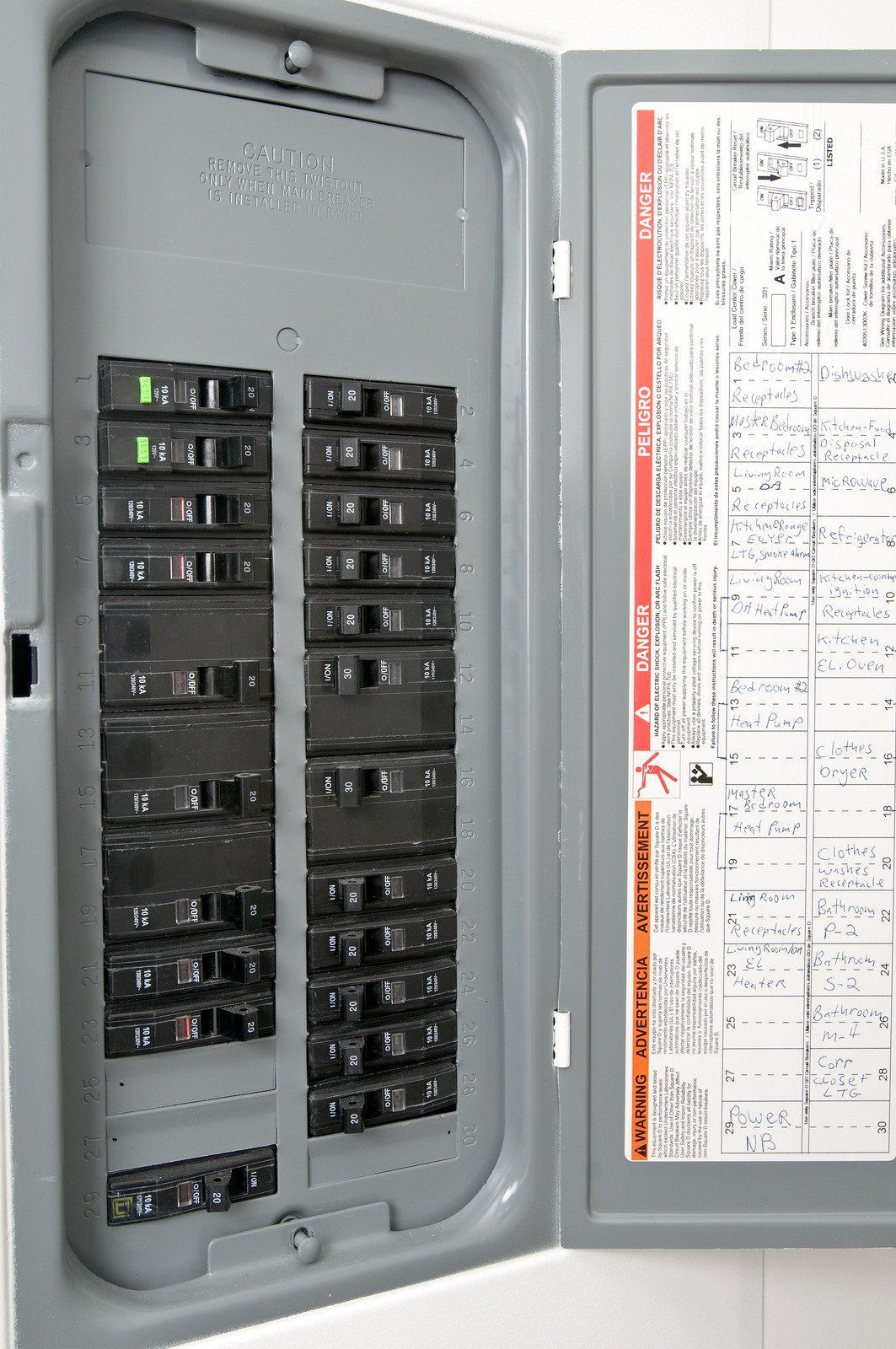 A close up of a electrical panel with the door open.