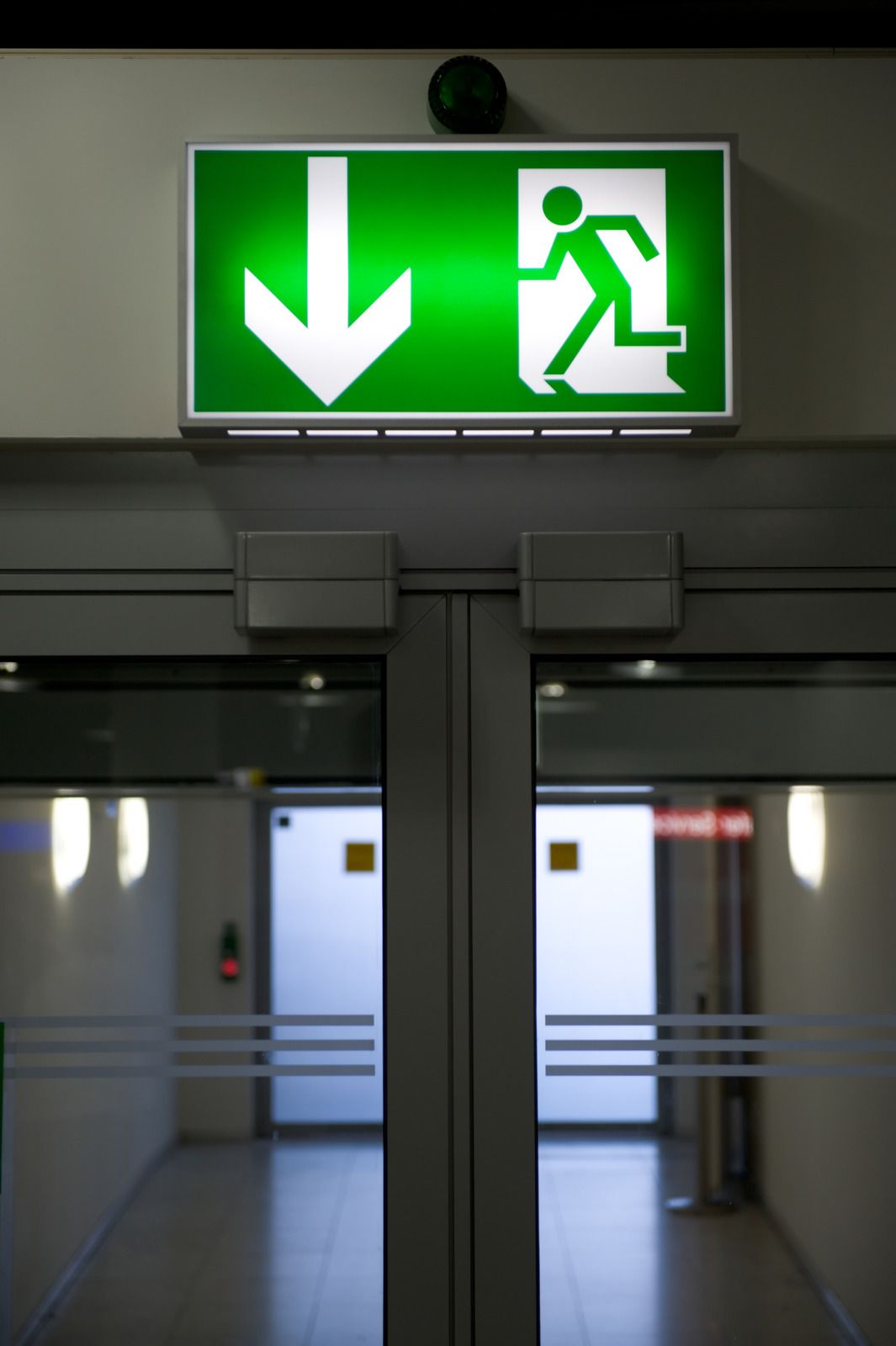 A green exit sign with an arrow pointing down