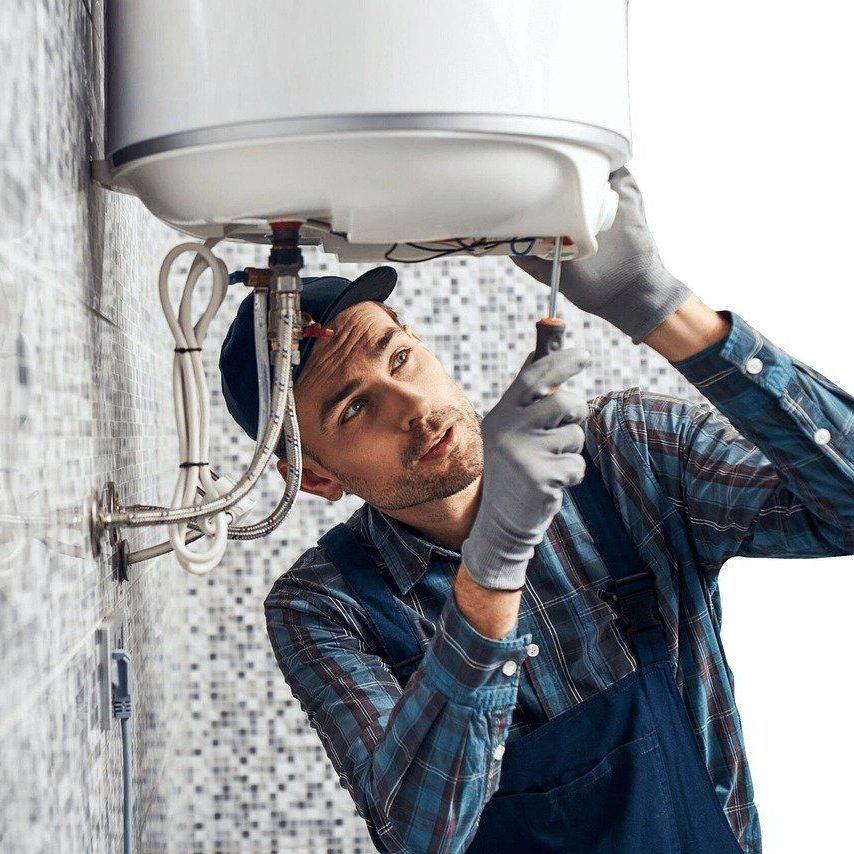 A plumber is fixing a water heater in Meriden, CT