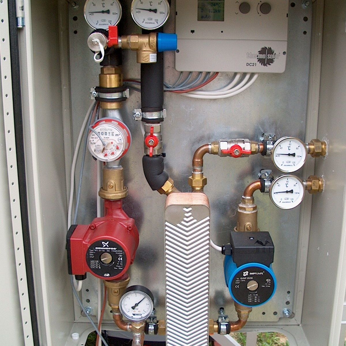 A person is adjusting a knob on a water heater.