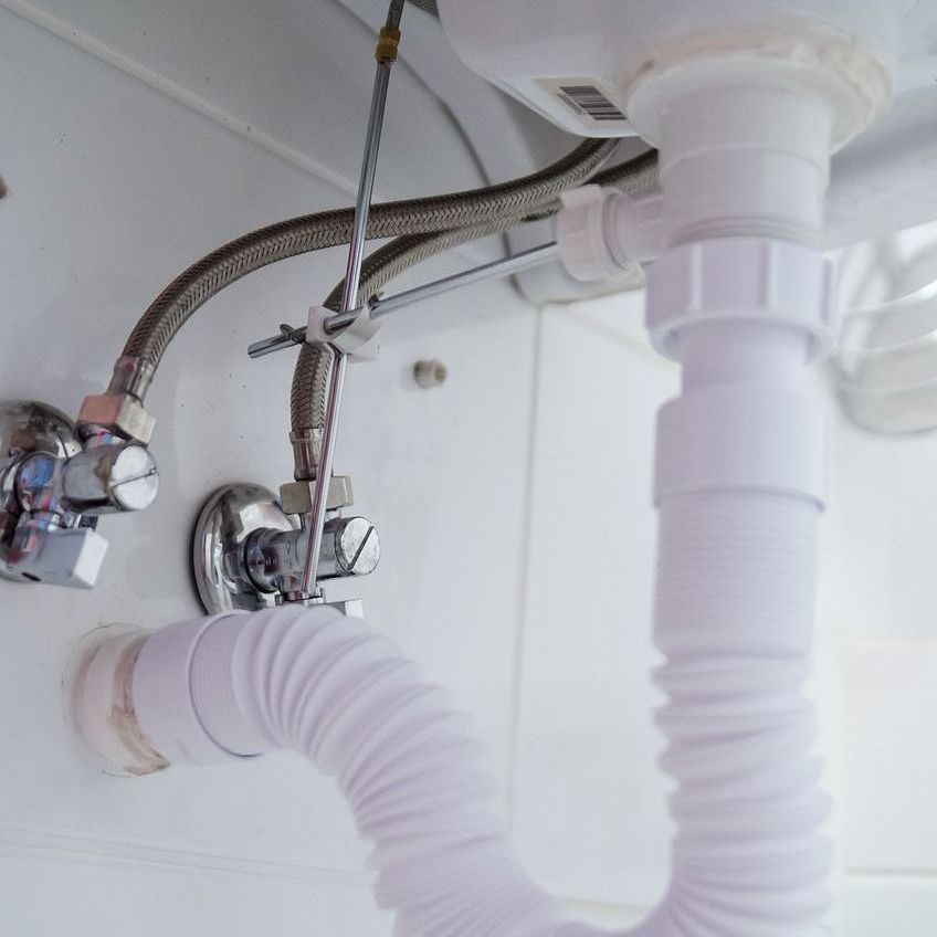 A bathroom sink with a flexible hose attached to it