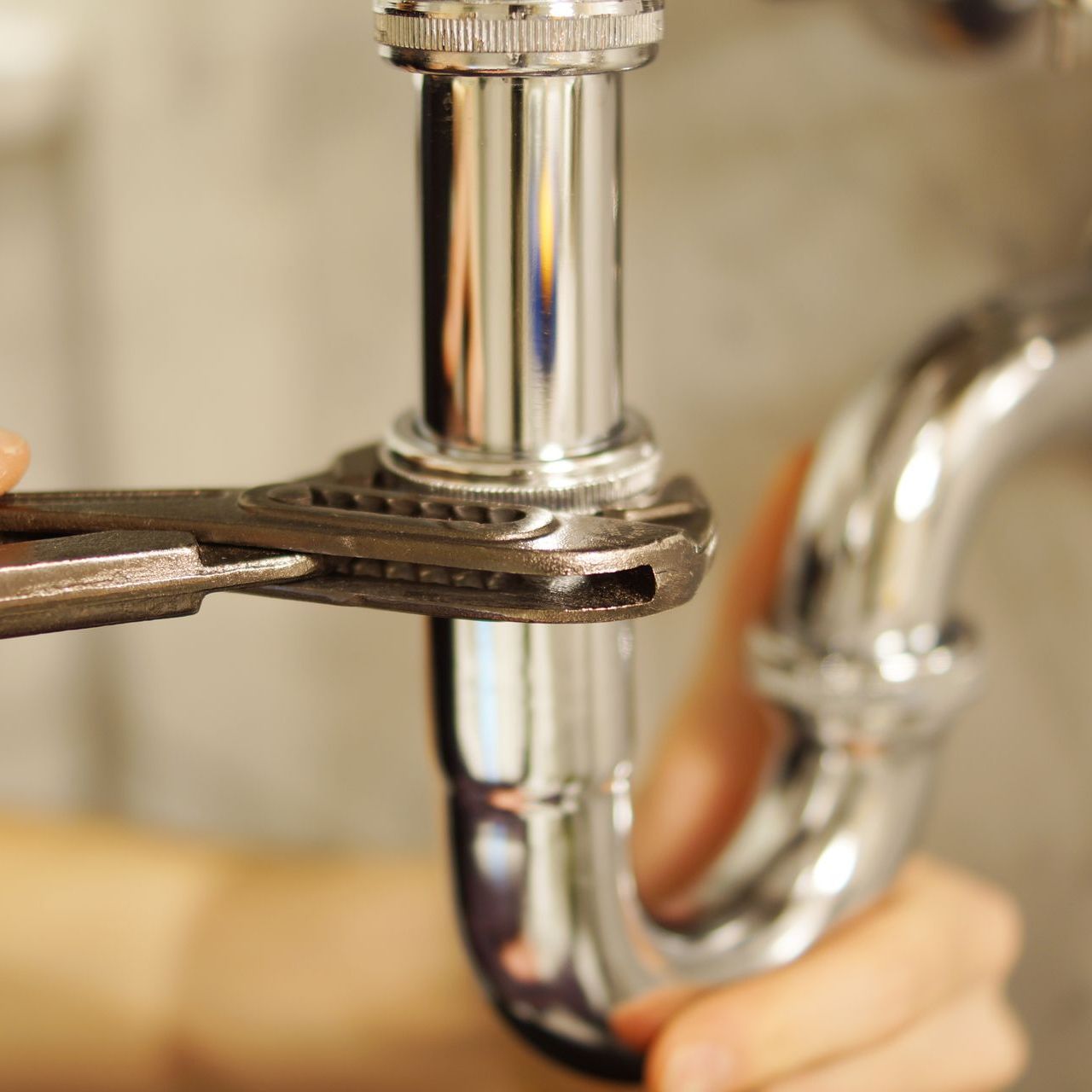 A person is adjusting a knob on a water heater.