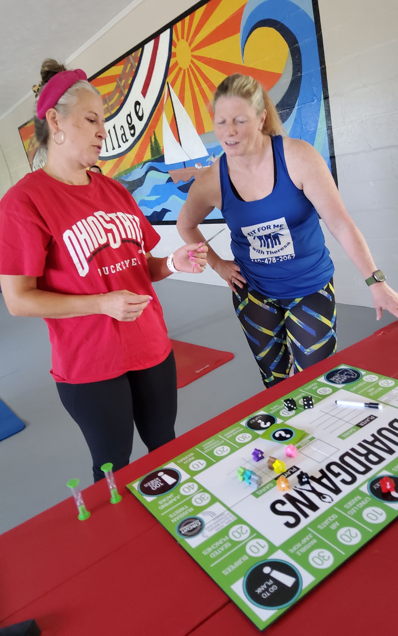 Two women playing a board game called