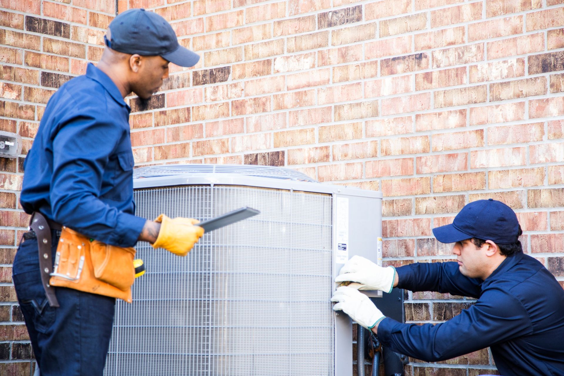 Complete Air technician performing fall AC inspection on outdoor condenser for Apopka, Florida home.