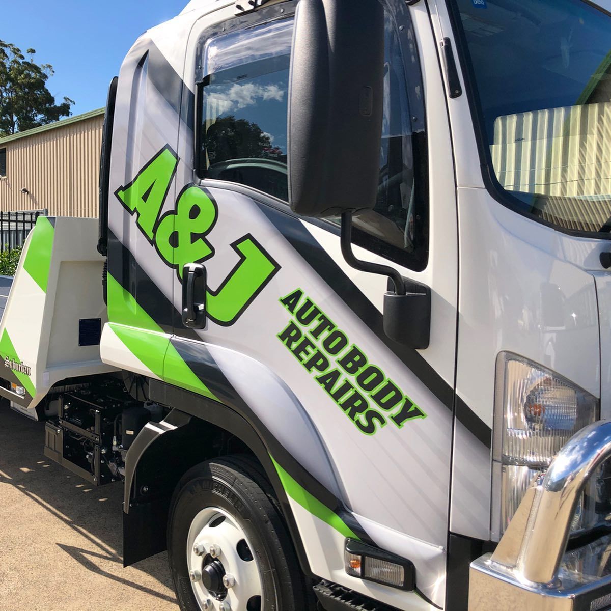 A White Truck With Green Letters That Says A & J Autobody Repairs — A & J Auto Body Repairs In Salamander Bay, NSW
