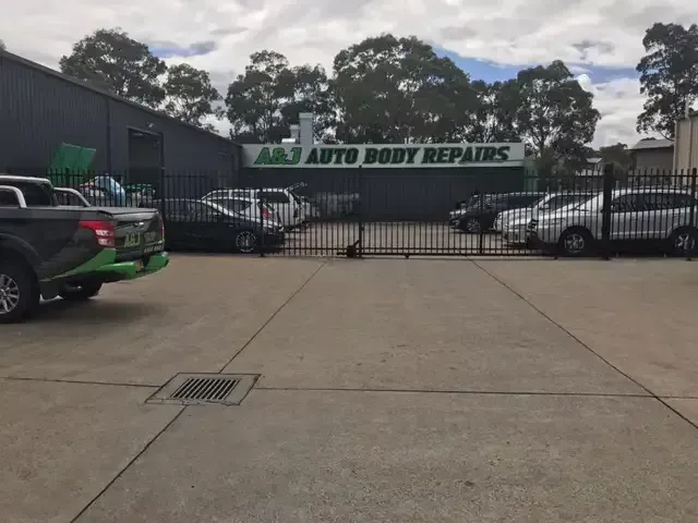 A Lot of Cars Are Parked in Front of an Auto Body Repair Shop — A & J Auto Body Repairs In Scone, NSW