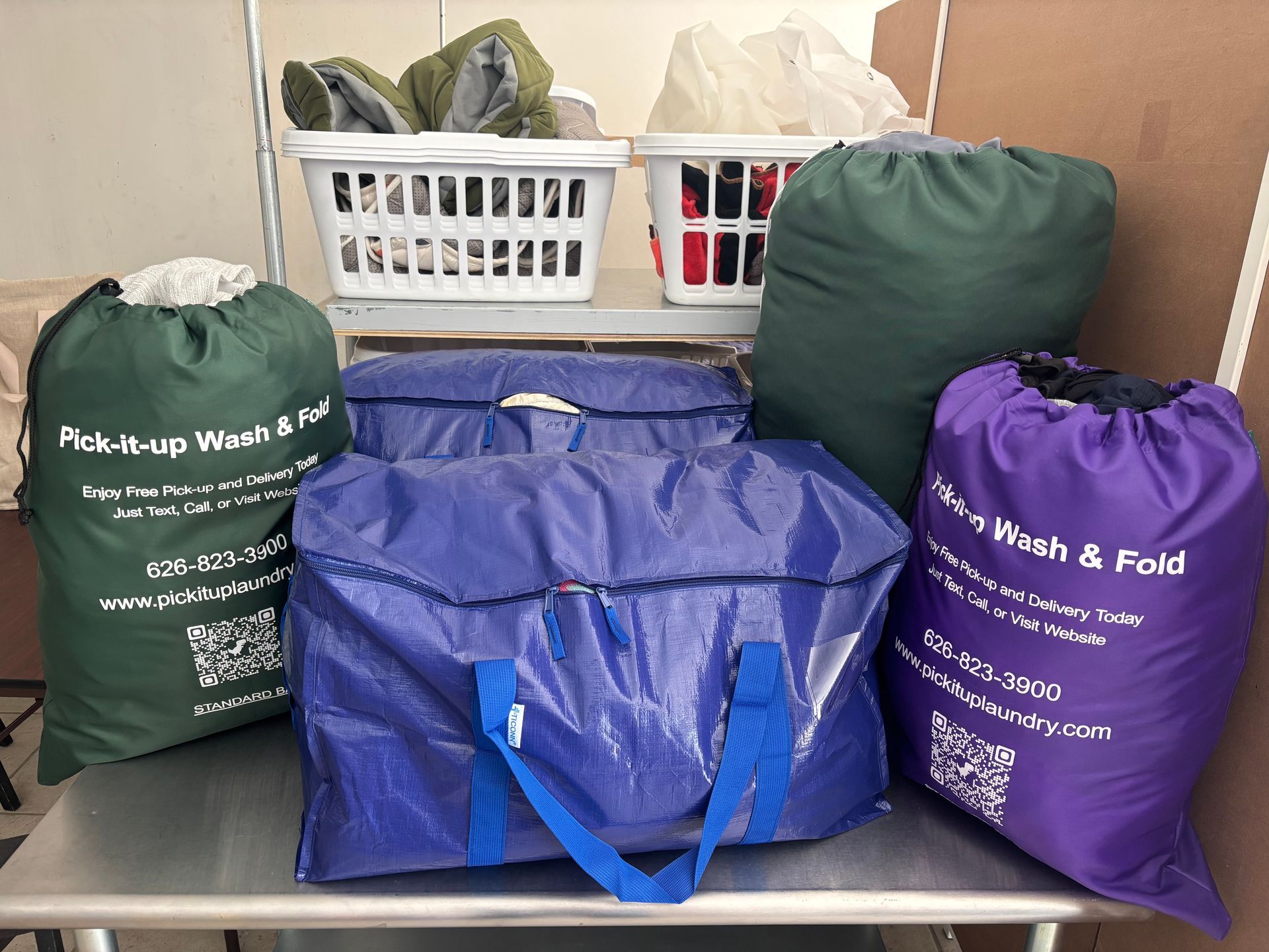 Interior of a white van with a blue bag on wooden planks, a metal cage and door open.