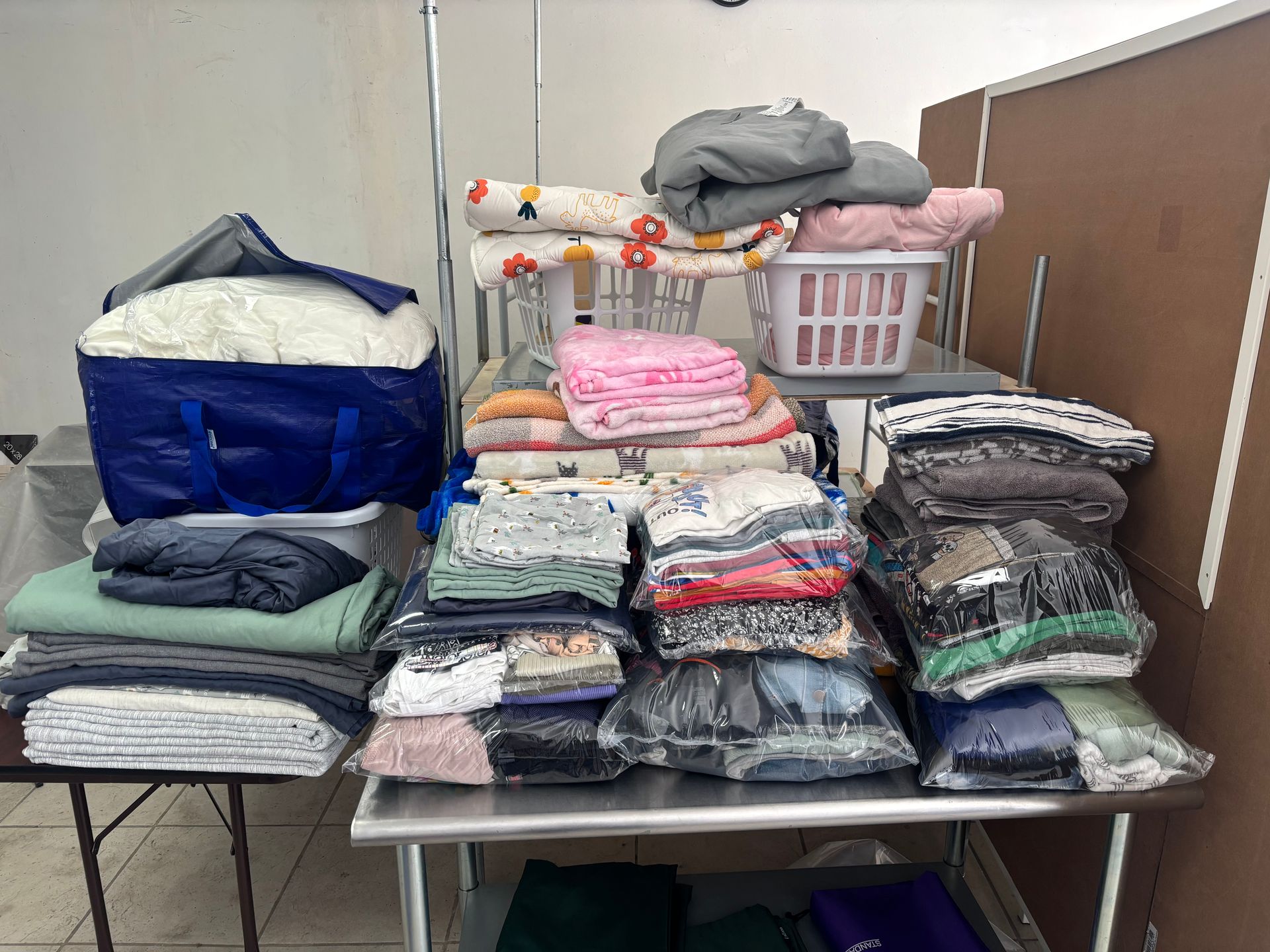 Plaid shirt on a wooden table under a large, gray heat press.