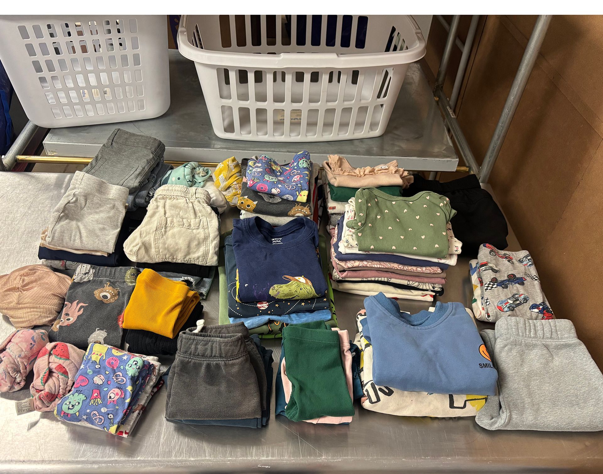 Hand reaching into a bag containing a blue and white Gracie Barra Jiu-Jitsu gi, in plastic packaging.