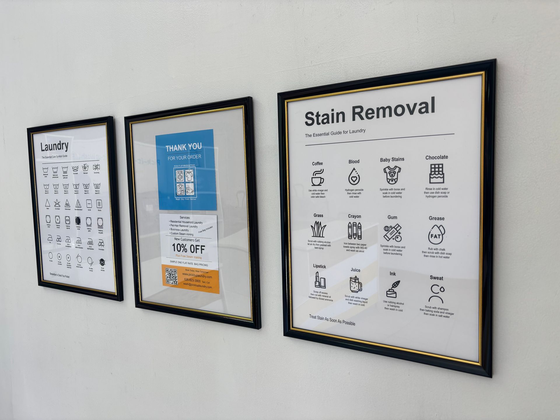 Assorted bedding sets, pillows, and blankets in clear plastic packaging on a table.