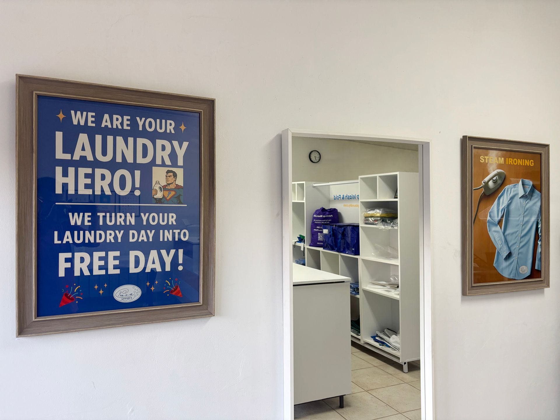 Folded laundry on a metal surface, including shirts, socks, and towels, with laundry baskets in the background.