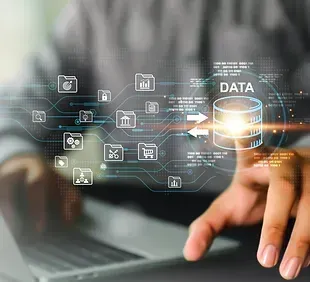 A person is typing on a laptop computer while using a virtual screen.