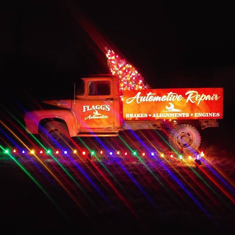 A vintage, rusty red truck with Christmas lights | Flagg's Automotive