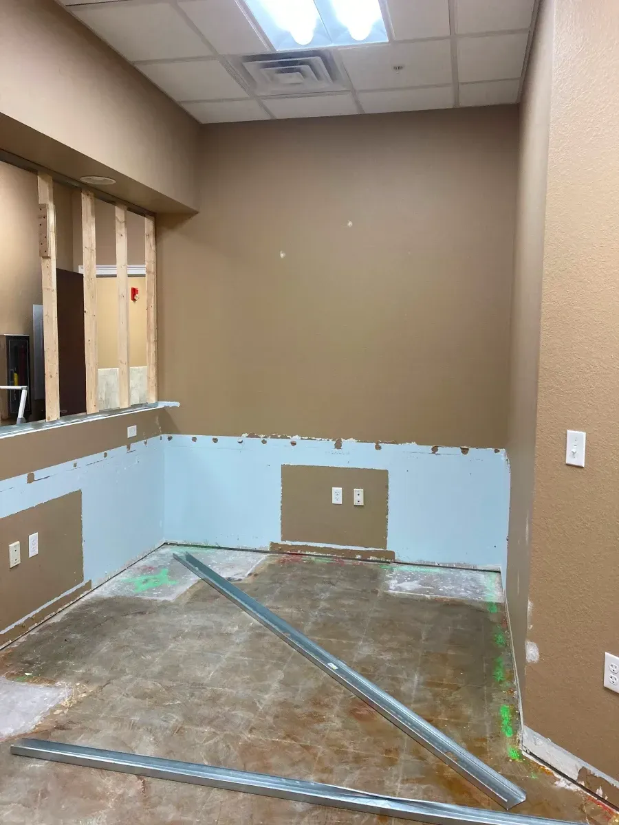 Interior room under construction, with exposed framing, drywall, and unfinished walls.