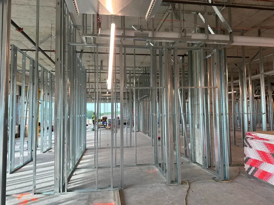Interior construction, metal framing for walls and doorways, unfinished space.