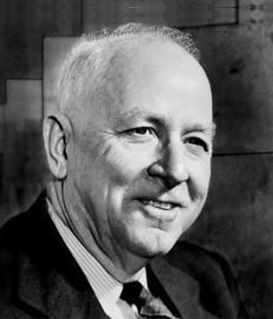 A portrait of a man in a dark suit and striped tie against a textured background.