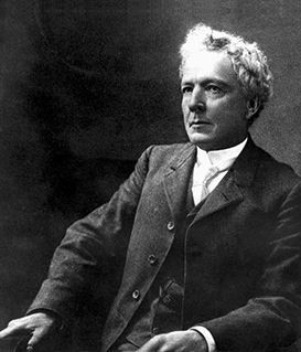 A formal black-and-white portrait of Robert La Follette in a dark suit, vest, and tie, looking slightly away from the camera.