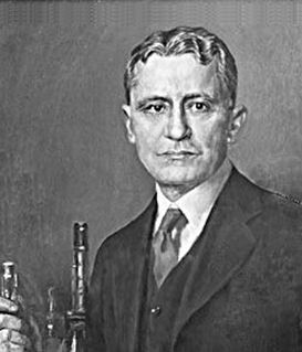 Portrait of American physician William P. Murphy, wearing a suit and holding a medical instrument against a plain background.