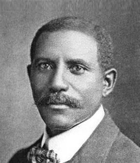 A black-and-white portrait of Granville T. Woods wearing a suit and bowtie, facing forward with a neutral expression.