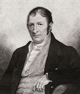 A black-and-white portrait of Sir Walter Scott wearing a dark coat, light vest, and white cravat, looking forward.