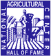 Blue and white logo of the National Agricultural Center and Hall of Fame featuring a farmer, a tractor, crops, and a cow.