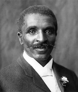 A black-and-white portrait of George Washington Carver, wearing a suit and bowtie, looking toward the camera.