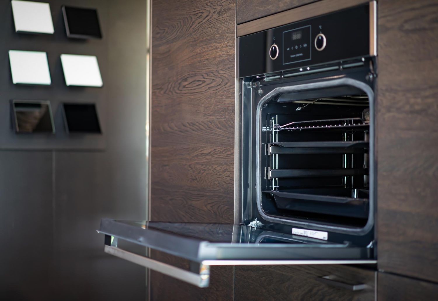 a stainless steel oven with the door open in a kitchen