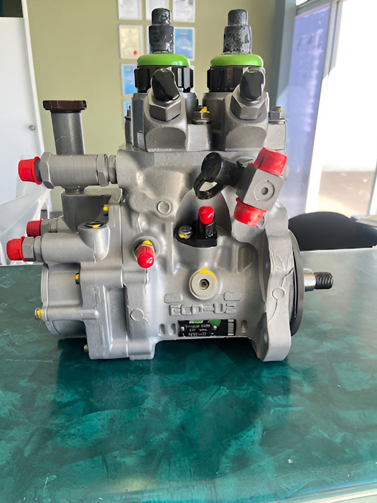 A Fuel Pump Is Sitting On Top Of A Green Table — AMC Diesel Fuel Injection Services In Paget, QLD